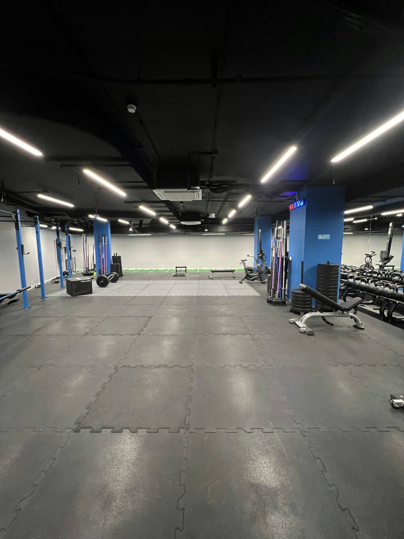Dark commercial gym interior with blue accent lighting